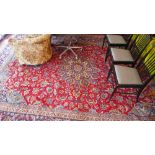 A large fine Isfahan carpet with central floral medallion on a red field contained by various floral