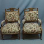 A pair of Edwardian mahogany armchairs with marquetry inlay having floral tapestry upholstery raised