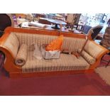 An early 20th century Biedermeier maple wood three seater sofa, with scroll arms and raised on