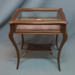 A 20th century mahogany bijouterie cabinet raised on cabriole legs joined by stretcher. H-74 W-59