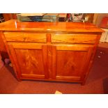 A 20th century French walnut side cabinet with two drawers over two long drawers raised on block