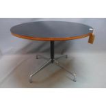 A Vitra circular dining table raised on steel and chrome base. H-74 Diameter-105cm