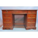 A 20th century mahogany pedestal desk with nine drawers raised on bracket feet. H-74 W-124 D-61cm