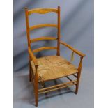 An early 20th century oak ladder back armchair with rush seat. (a/f)