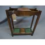 A 20th century oak umbrella stand with key box and drip trays