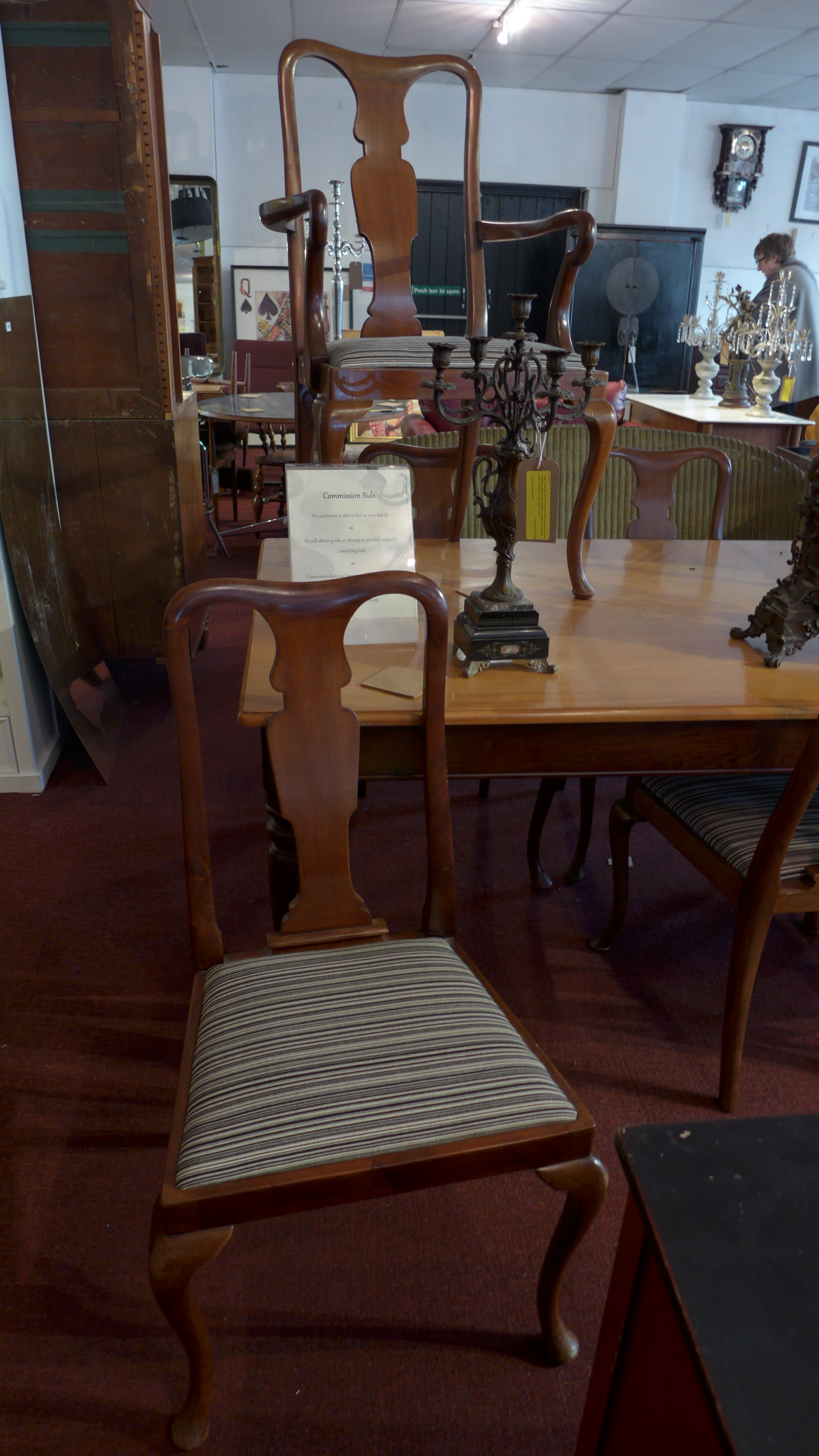 A set of six Queen Anne style walnut dining chairs together with two matching carvers