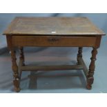 An early 19th century oak side table with single drawer raised on turned legs joined by stretcher.