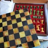 An Italian Chiellini chess set, with board, chess pieces and chequers, 34 x 34cm