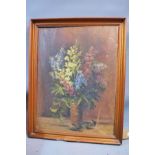 An early 20th century oil on canvas depicting a still life of flowers. 67x50cm (a/f)
