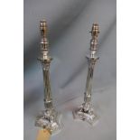 A pair of silver plated Regency style Corinthian column table lamps, H. 52cm (no shades)