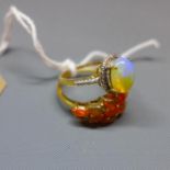 An opal and silver gilt dress ring together with a fire opal silver gilt dress ring