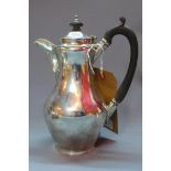 An early 20th century silver teapot, having ebonised handle and finial, London 1919, bears makers