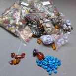 A large collection of semi-precious stones to include tigers eye, turquoise, amber, rose quartz ect.