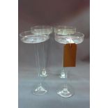 Four glass candle holders H.38cm