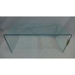 A Contemporary curved glass low table, H. 42cm W. 99cm D. 49cm