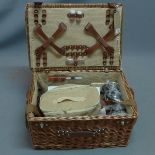 A Contemporary wicker picnic basket with fully fitted interior.