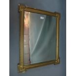 A 20th century gilt wood mirror with beveled glass plate.