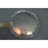 A silver tray with scalloped rim, on three scroll feet, William Hutton & Sons Ltd, Sheffield 1931,