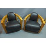 A pair of Art Deco style veneered burr walnut armchairs with black leather upholstery.