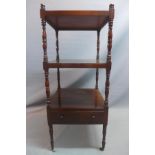 A 19th century mahogany three tier whatnot with single drawer raised on turned supports and castors.