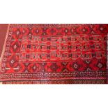 A fine North East Persian Meshad Belovch rug, 220cm x 94cm, repeating stylised geometrical motifs on