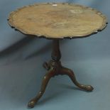 An oak tilt top table with pie crust edge