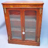 A Victorian walnut pier cabinet with marquetry inlay and ormolu mounts raised on stepped base. H.