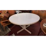 A Gordon Russell breakfast table with white laminate top with pillar support and x-frame base. H-