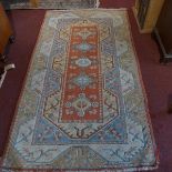 A Turkish Milas rug, with five geometric diamond pole medallion, on a red ground, contained by
