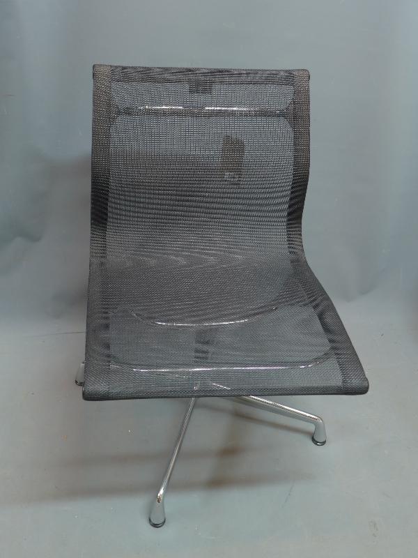 A Charles Eames for Vitra swivel desk chair with black mesh seat, raised on chrome base, having