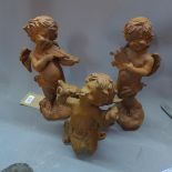 Three cast iron cherubs playing musical instruments, H. 30cm tallest (3)