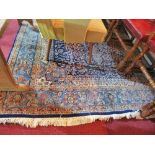 A South Persian Kirman Laver blue ground rug, having a central floral medallion, multi-bordered