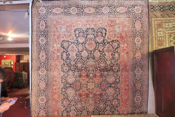 An extremely fine Indian pure silk carpet, having central floral motifs, on a dark blue ground,