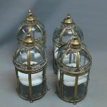 A set of four gilt metal storm lanterns