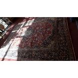 A fine Central Persian Kashan carpet, double pendent medallion on a rouge field within stylised