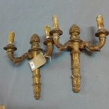 A pair of giltwood two branch wall lights, and a pair of gilt metal Rococo style wall lights with