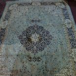 A Kashan style carpet, with central floral medallion, on a green ground, contained by floral