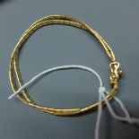 An 18ct yellow gold double chain bark effect bracelet, marked 750, appox. 12g