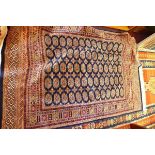 A Bokhara style rug, with elephant pad motifs, on a blue ground, contained by geometric borders, 190