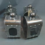 A set of four industrial storm lanterns, H. 43cm