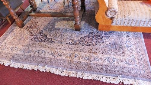 A Persian Indo Bidjar carpet with three graduating floral medallions contained by repeating floral