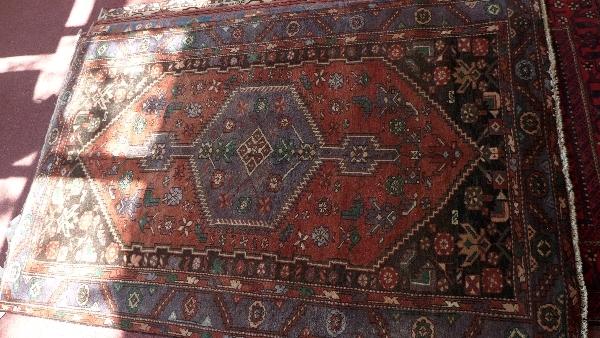 A fine North West Persian Zanjan rug, central diamond medallion on a madder ground within stylised