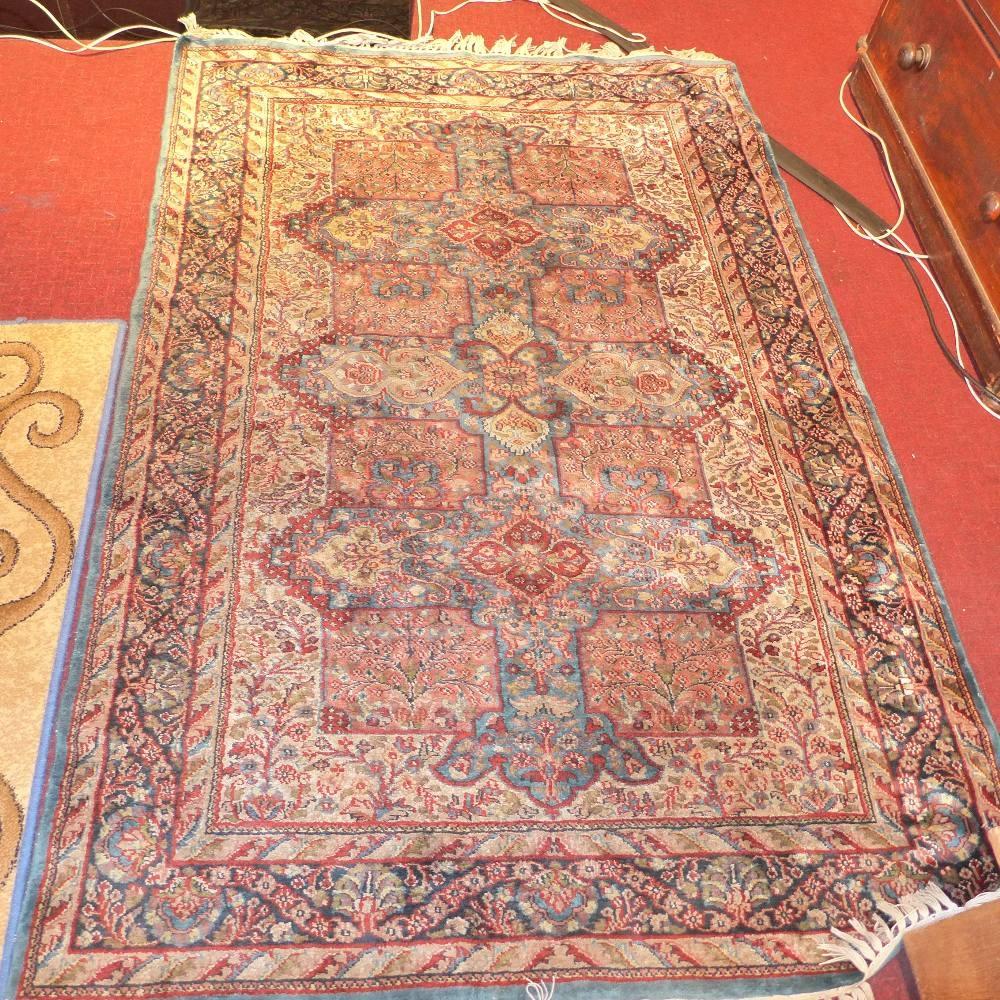 A green ground Persian rug, 185 x 125cm