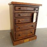 A 19th/20th century burr walnut table top chest of five graduating drawers, with marquetry inlay,