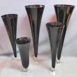 A collection of five black glass vases, H.101cm