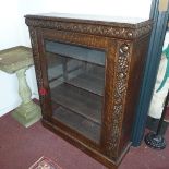 A 19th century carved oak bookcase, with glazed door, raised on stepped base, H.113 W.91 D.29cm
