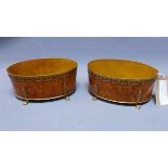 A pair of 18th century style metal planters, with burr walnut effect, raised on paw feet