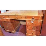 A 20th century pine pedestal desk, with eight drawers, H.77 W.136 D.64 cm