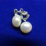 A pair of Art Deco style 18ct white gold and pearl earrings, inset with blue sapphire flanked by
