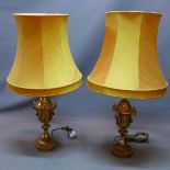 A pair of 20th century architectural style brass table lamps, with shades, H.50cm